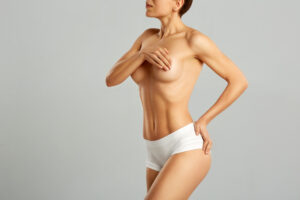 A woman covering her breasts after plastic surgery in Scottsdale